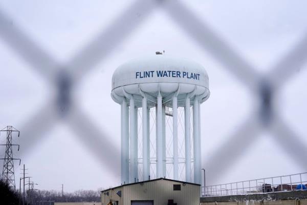 FILE - The Flint water plant tower is seen on Jan. 6, 2022 in Flint, Michigan. Residents in the majority-Black city were exposed to lead after the city used Flint River water and didn't treat it to reduce the corrosive effect on old pipes.