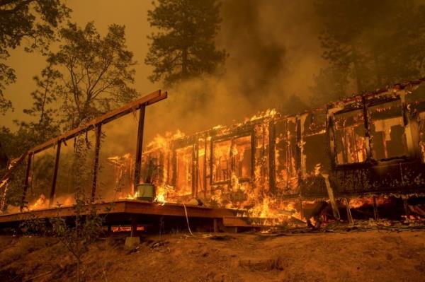 A home burns as the Butte Fire rages near Mountain Ranch, California, in 2015.